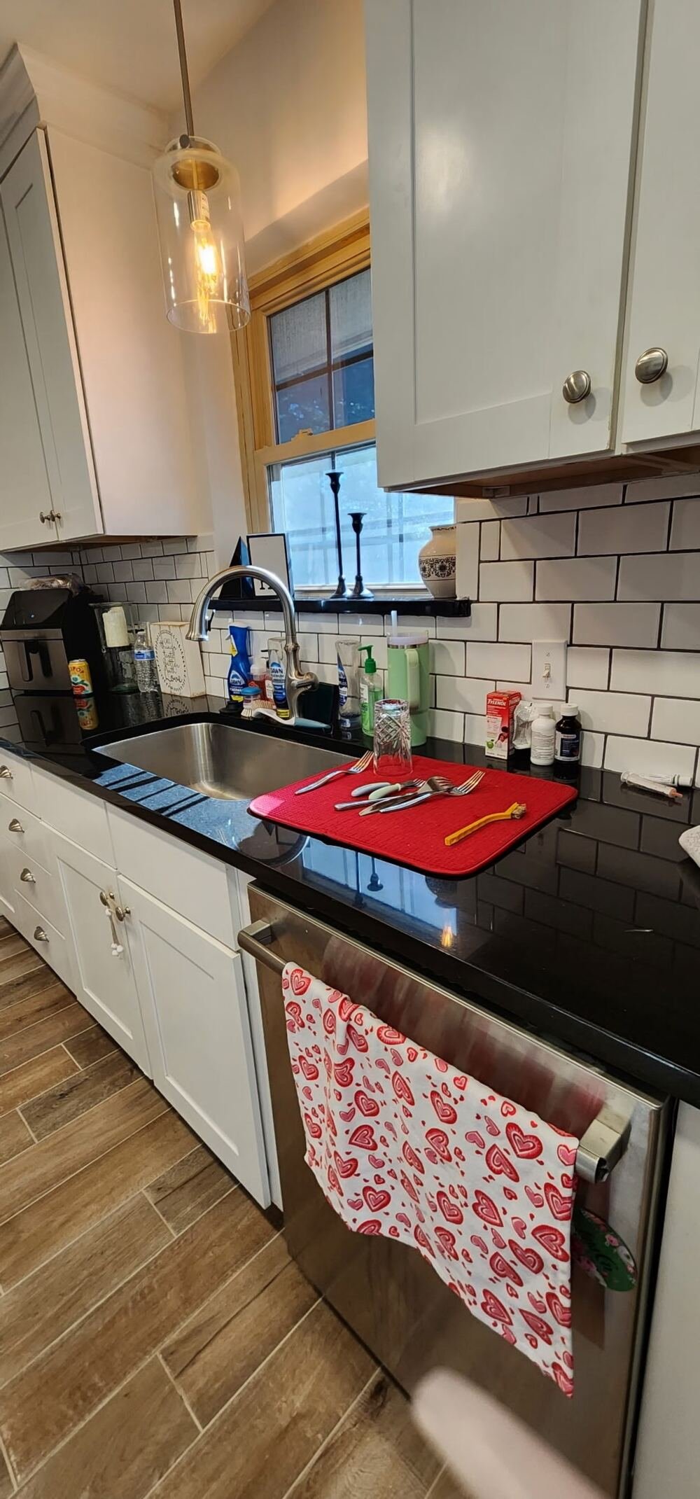 Kitchen with black granite counters, spotlessly cleaned